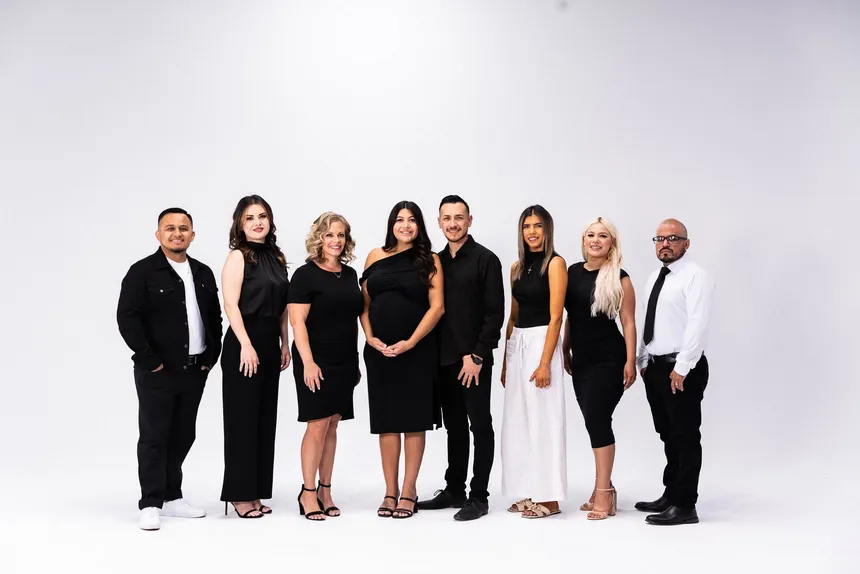 The Momentum Brokers team standing together in a bright studio